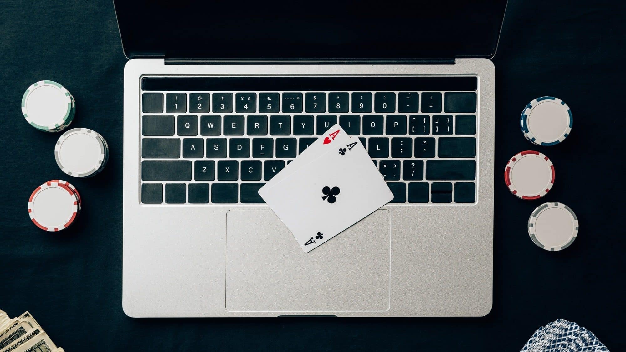 Online gambling concept with chips and money on laptop